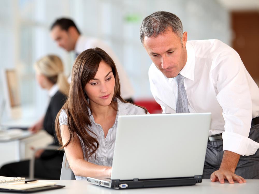 A procurement officer working with a colleague.