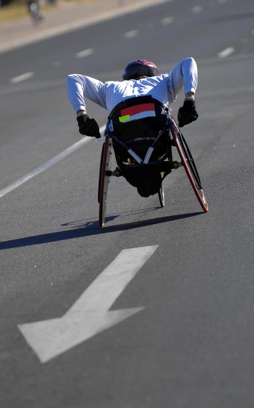 An amputee racing in a wheelchair.