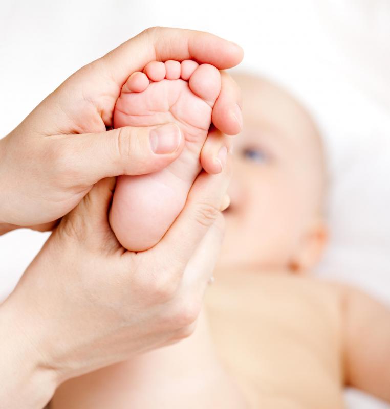 Baby's foot being massaged.