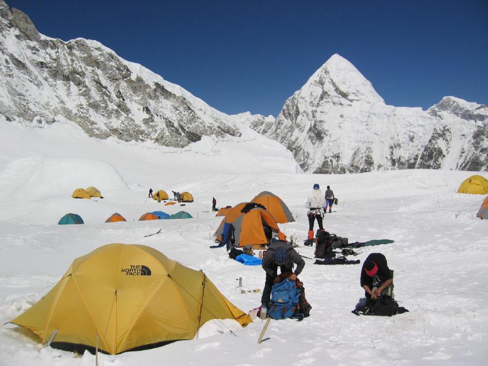 A group of three British extreme ironists pressed a Union Jack flag at the Mount Everest Base Camp in 2003.