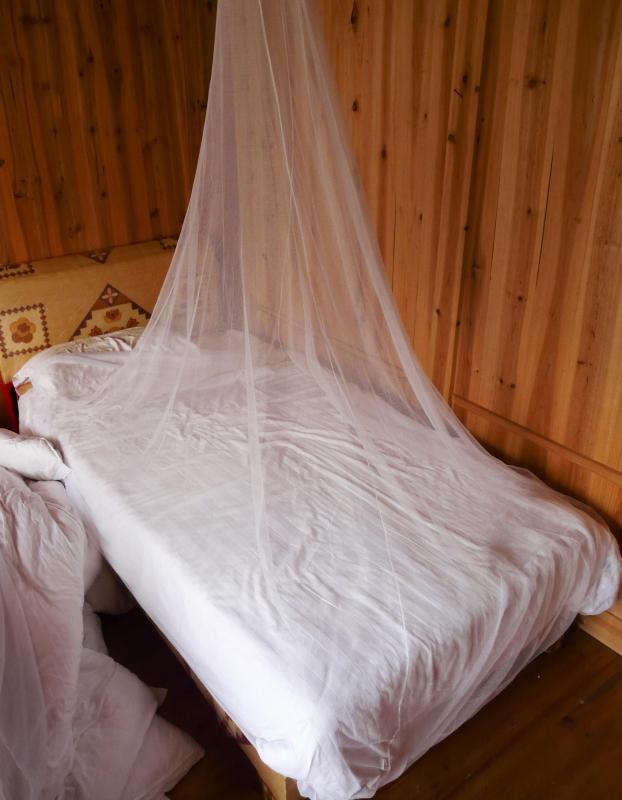 One way to prevent malaria is by hanging mosquito netting over the bed.