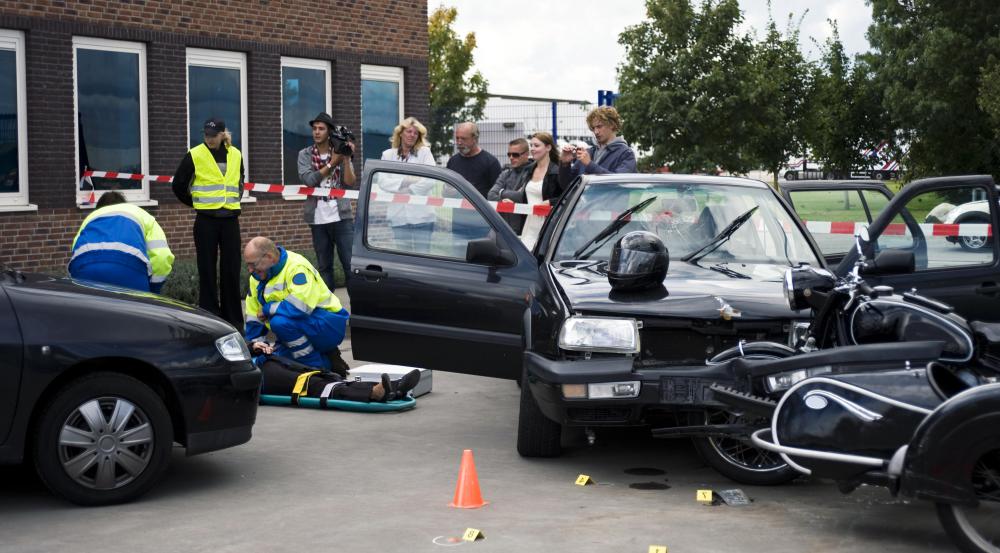 Emergency personnel respond to the scene of an accident to provide aid.