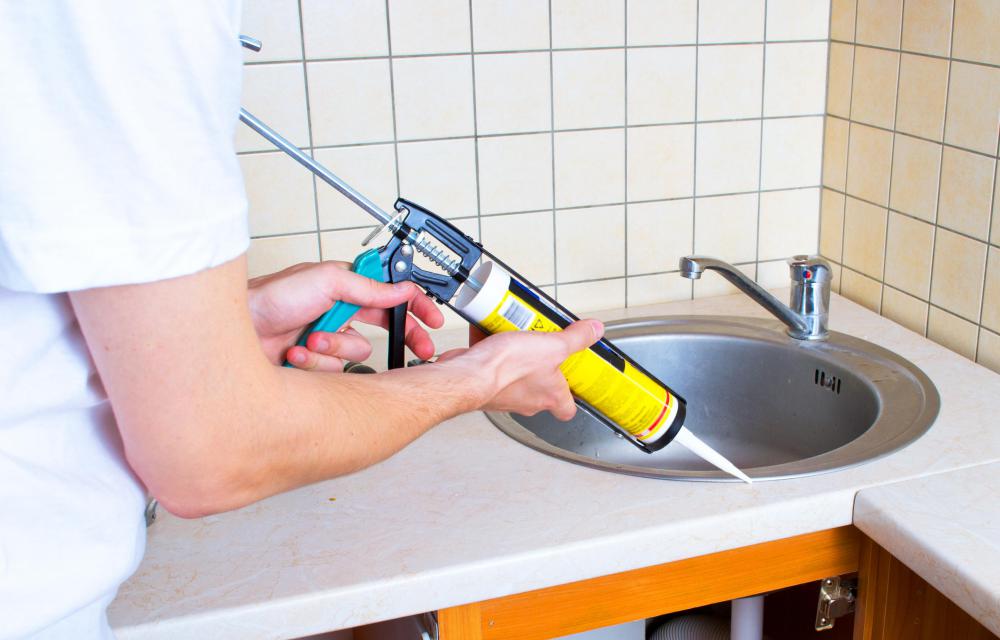 A caulking gun can be used to fill in some of the smaller cracks in a driveway.
