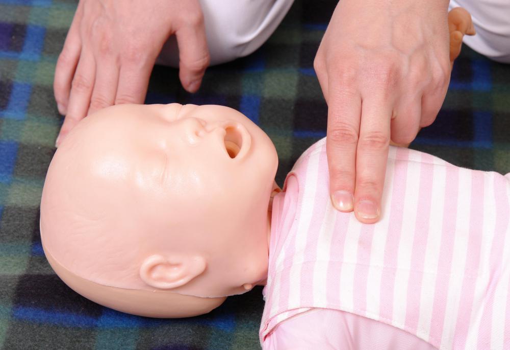 A man demonstrating correct CPR technique on an infant.