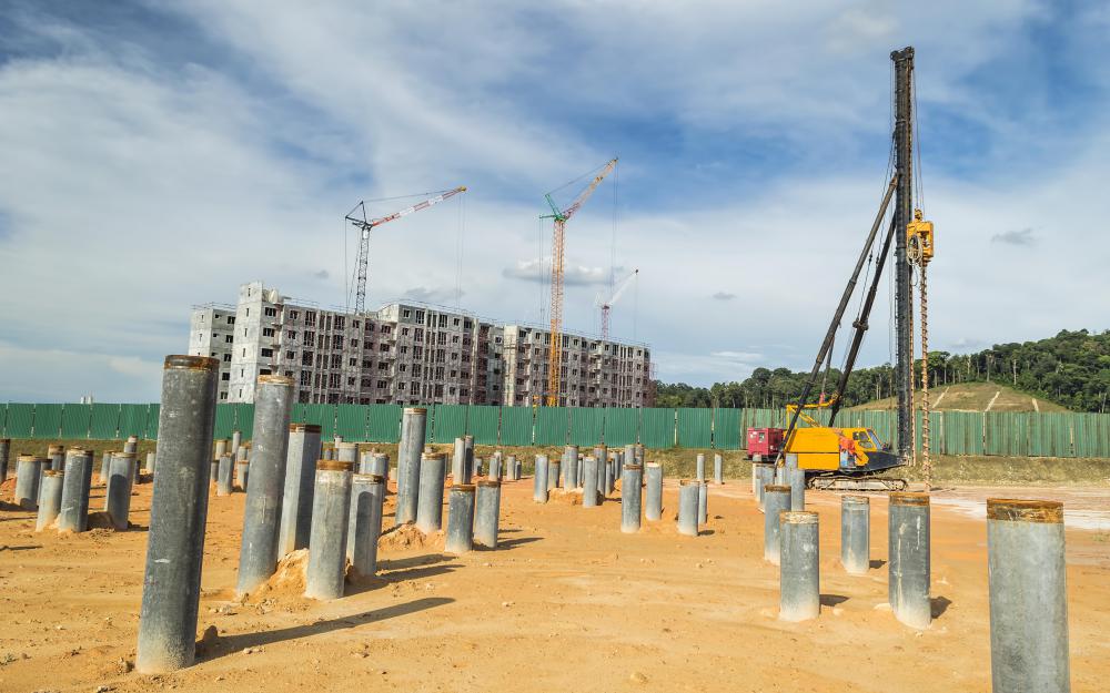 A concrete pile is driven into the ground to ensure that a foundation is deep.