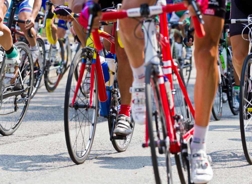 A stage race involves riders starting en masse and using team tactics to get ahead of the pack.