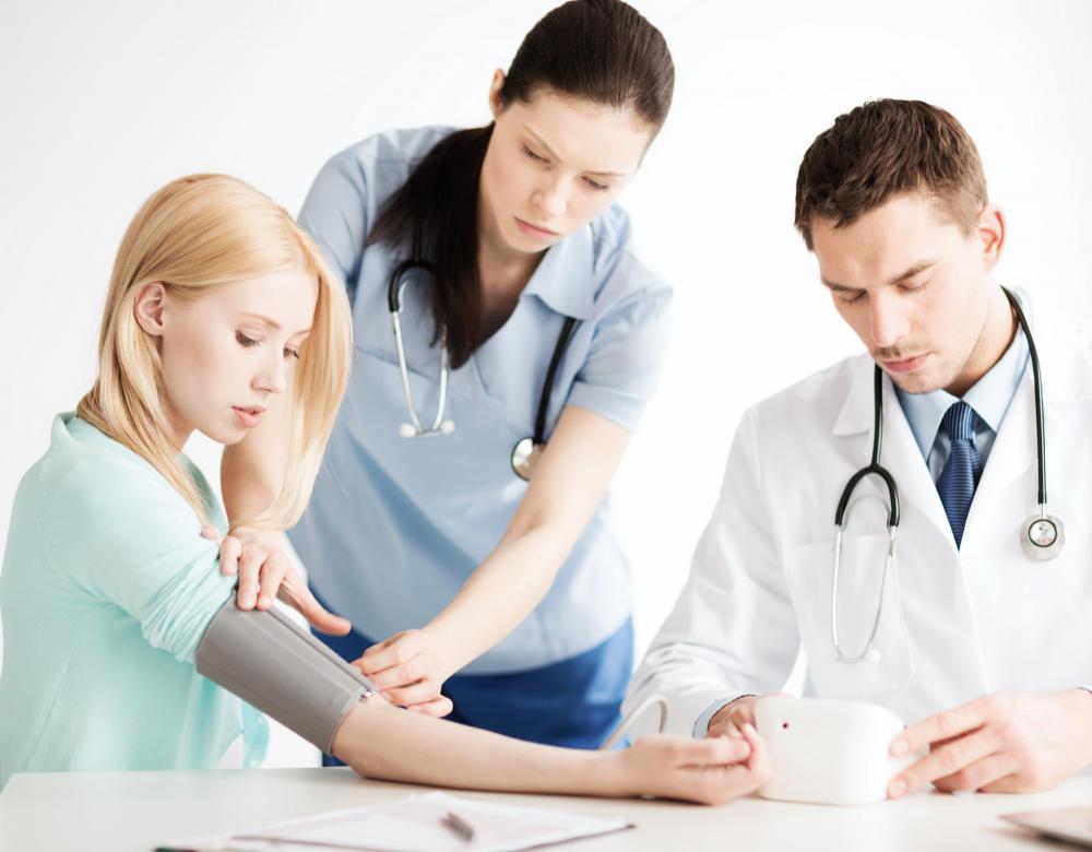 A technician in the catheterization lab might monitor blood pressure.