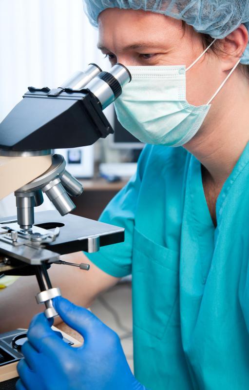 A crime lab analyst inspects material evidence from crime scenes.