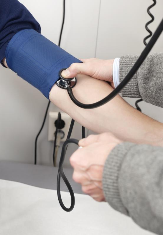 A doctor taking a patient's pulse rate.
