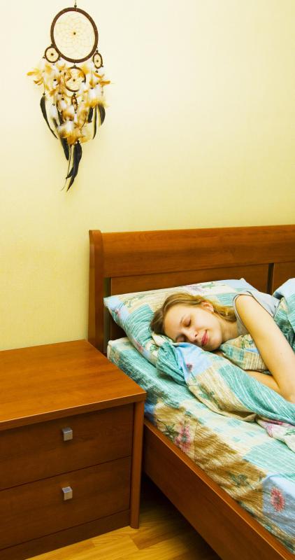 Dream catcher over a woman's bed.