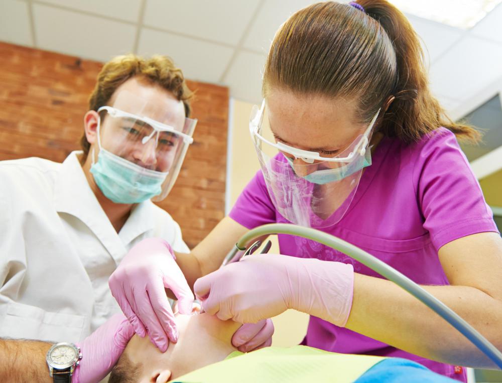 During four-handed dentistry, a dental assistant works alongside a dentist at the same time.