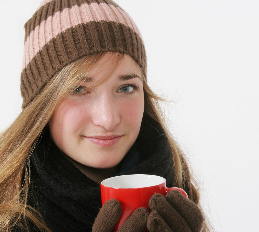 Woman in skully hat and gloves.