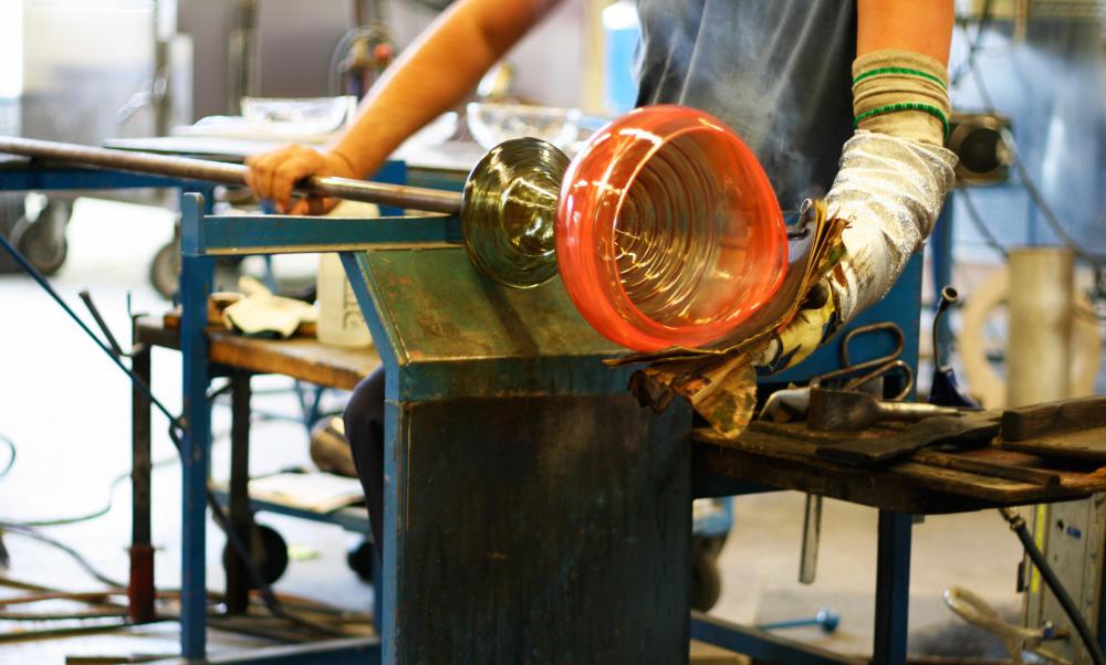 A glass blower working at his bench.