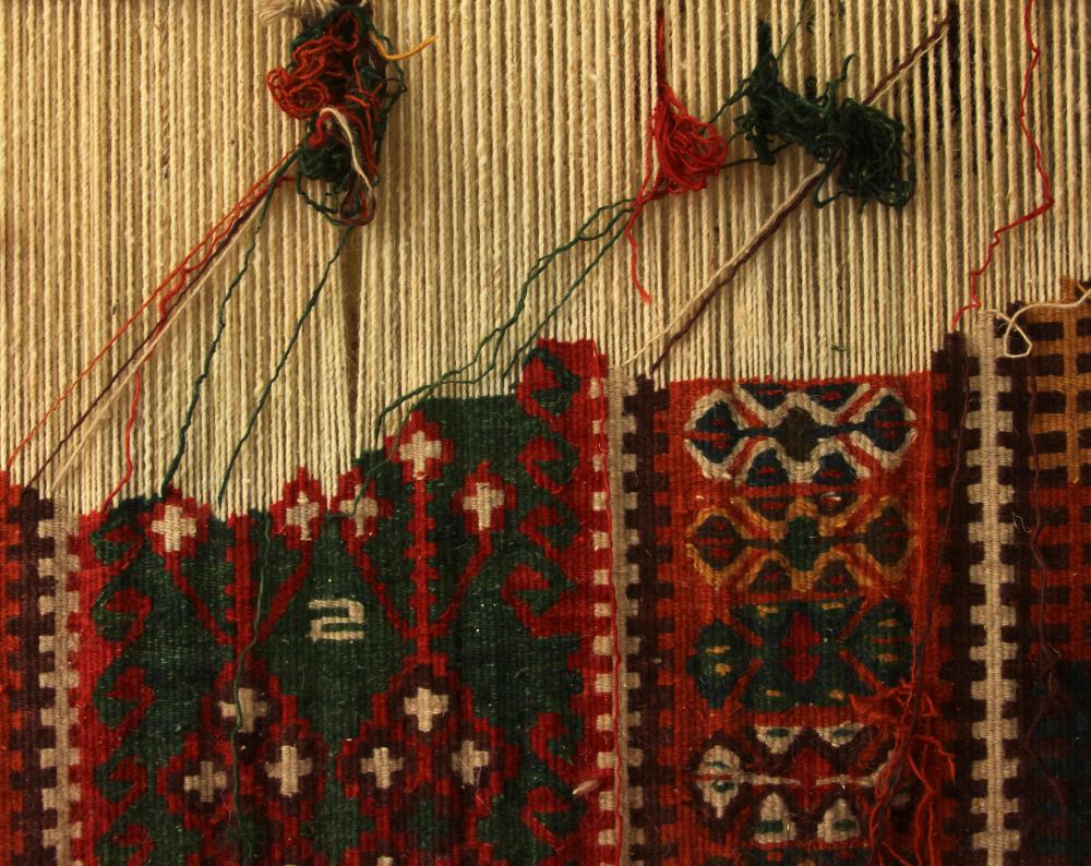 Handwoven fabric with coarse warp and delicate weft.