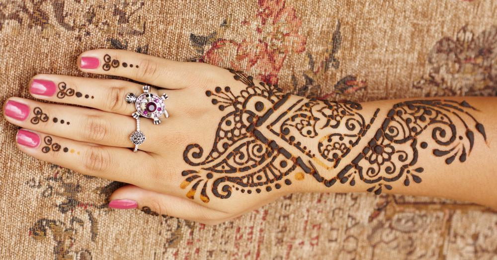 A henna tattoo on the arm and hand.