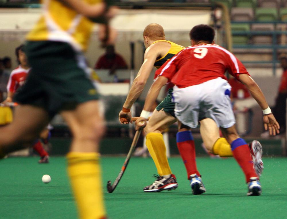 Field hockey players may only strike the ball with the flat part of their stick.