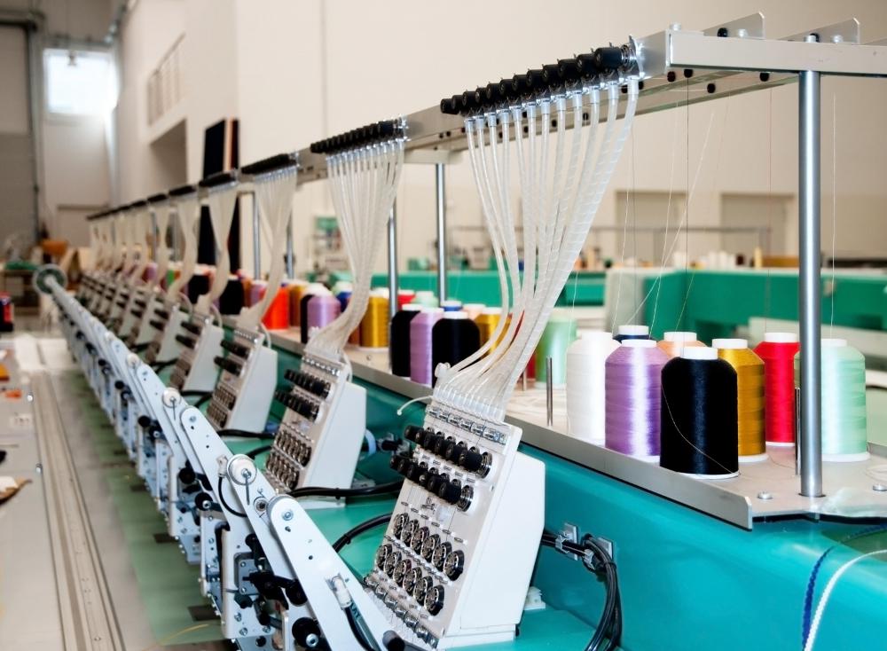 Embroidery, which could be done with an industrial machine or even by hand, is decorative, whereas sewing is constructive.