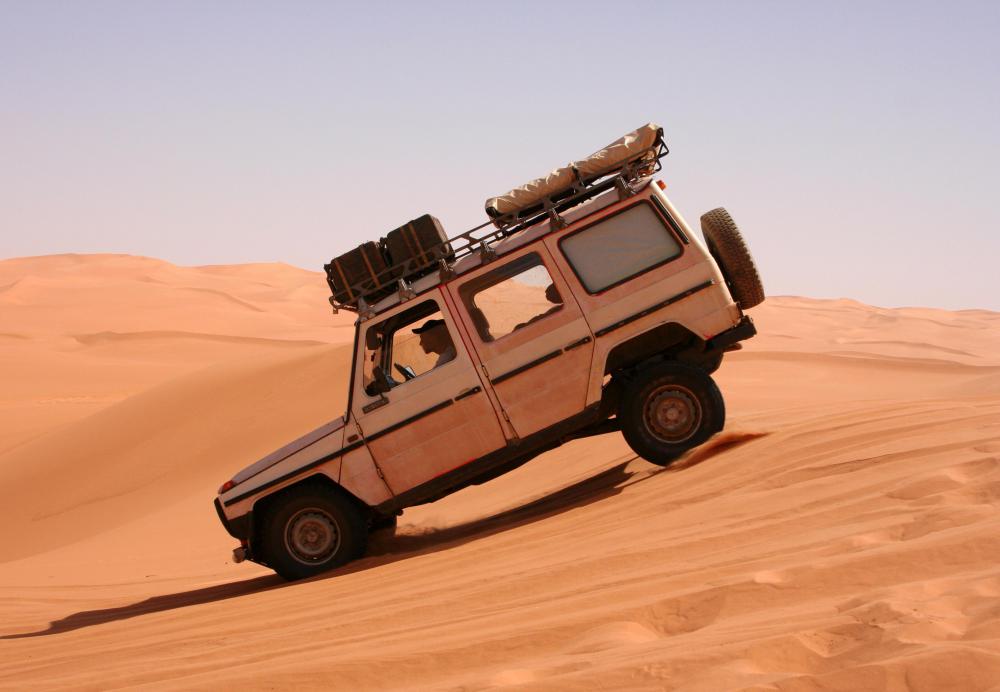 A driver must apply the brakes to compensate for the intertia gravity creates as a car goes downhill.