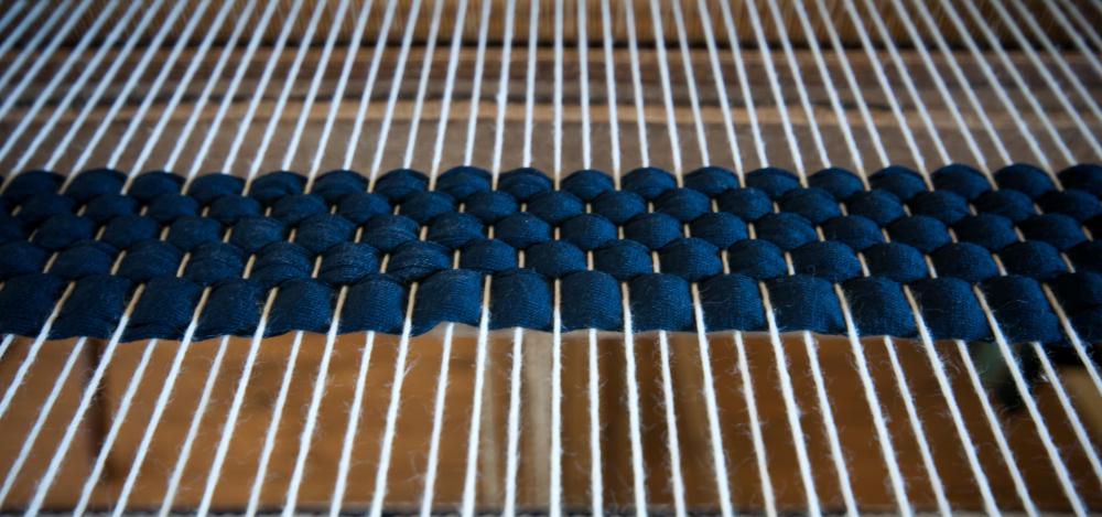 Loom with white warp and blue weft.
