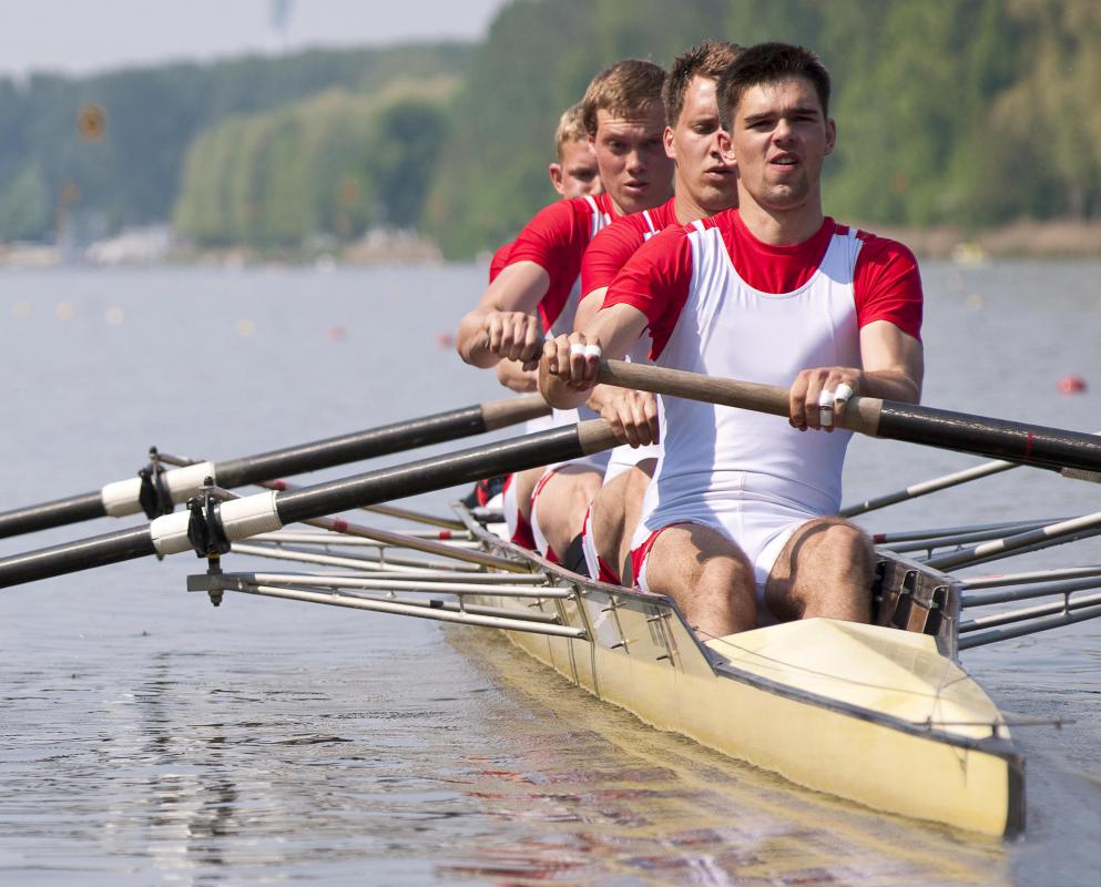 Rowing a boat -- or using a rowing machine at the gym -- uses the lat muscles of the back as well as muscles in the legs and arms.