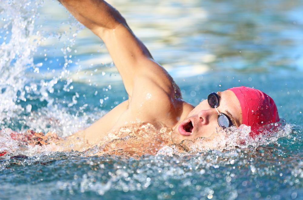 Swimmers swim laps while being timed to improve their performance.