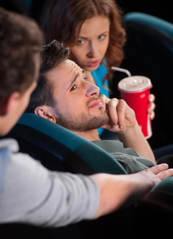 It's quite rude to talk on a cell phone while in a movie theater, even if the film hasn't started yet.
