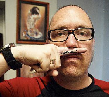 A man showing a fingerstache.