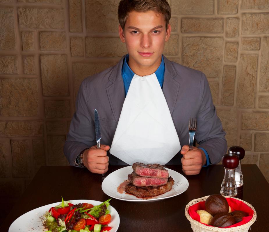 Microscopic organisms can enter the human body through the ingestion process by consuming undercooked or improperly prepared food.