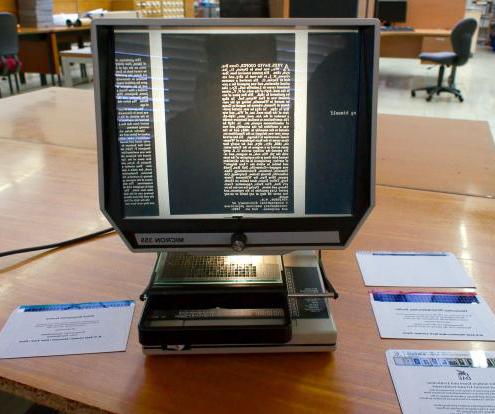 A sheet of microfiche contains miniaturized reproductions of documents such as newspaper articles or scientific journals.