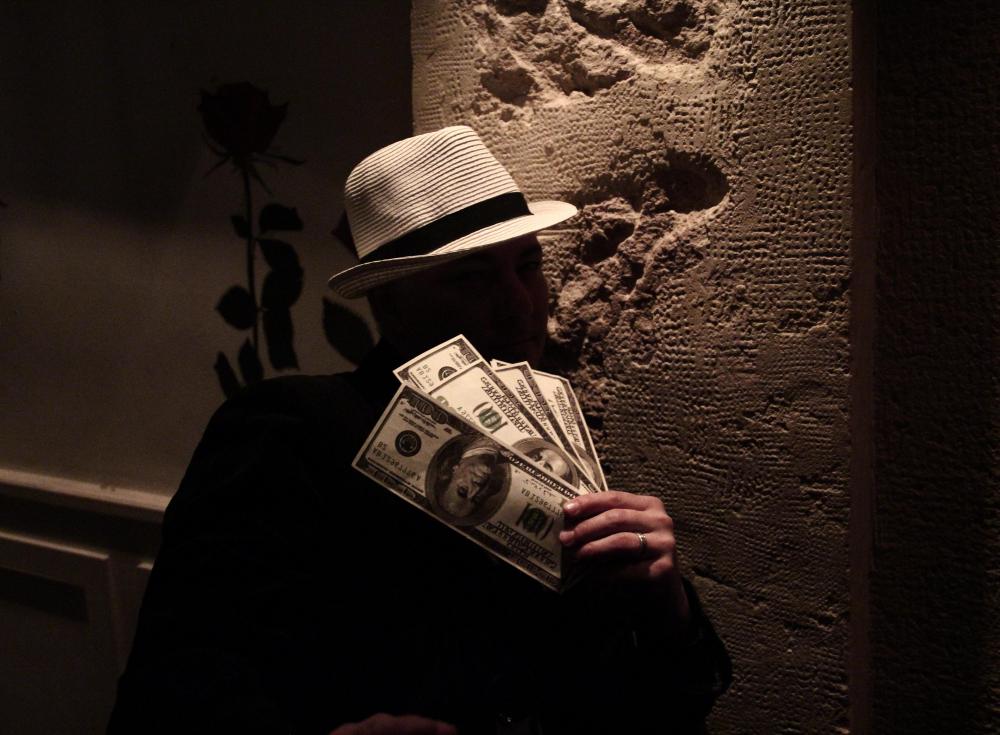 Shadowy figures offering bribes are one common trope in the mystery genre..