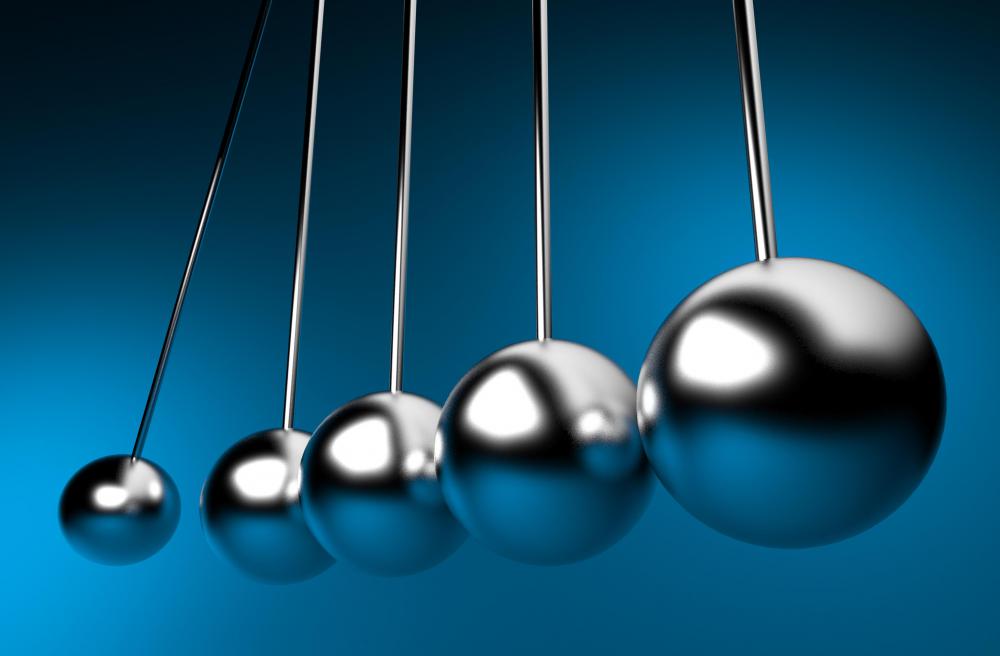 Energy is transferred across from one ball to another, but is also lost due to friction and gravity, preventing perpetual motion.