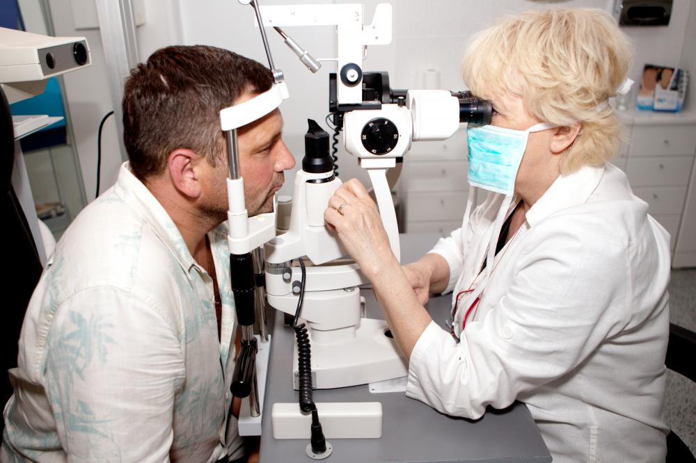 An optometrist examining a patient for eye defects.