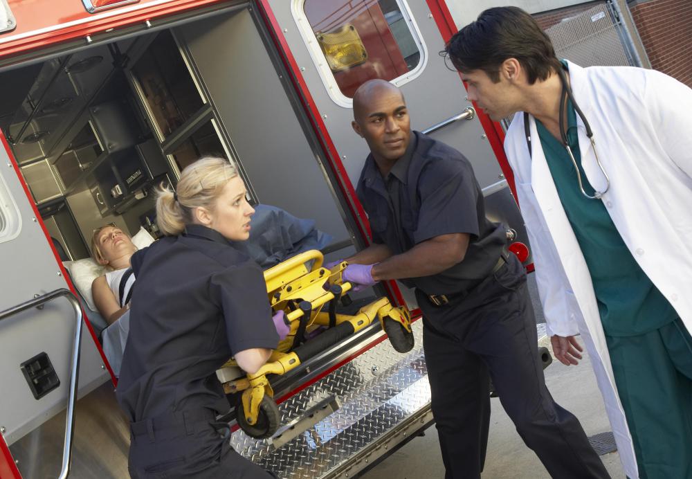Paramedics brief doctors on a patient's condition when they arrive at a hospital.
