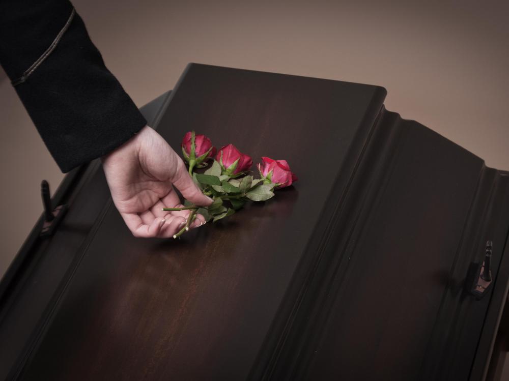 Many people place flowers on coffins as gifts for the dead.