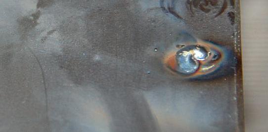 A plug weld joining two pieces of sheet metal together.