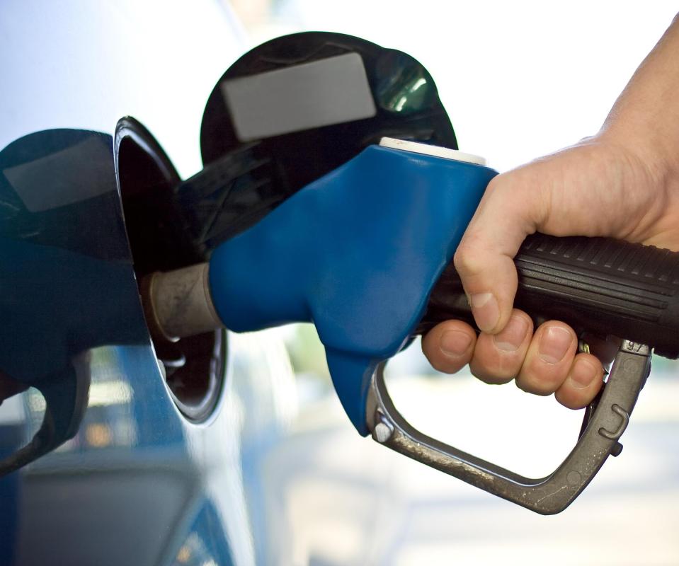 A man filling up his gas tank.