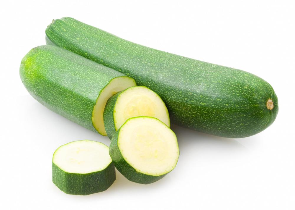 Raw sliced zucchini, which is celebrated on Sneak Some Zucchini onto your Neighbor’s Porch Day.