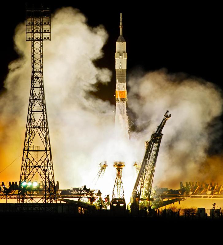 Launching a rocket from the equator can minimize the necessary fuel by taking advantage of the Earth's rotation.
