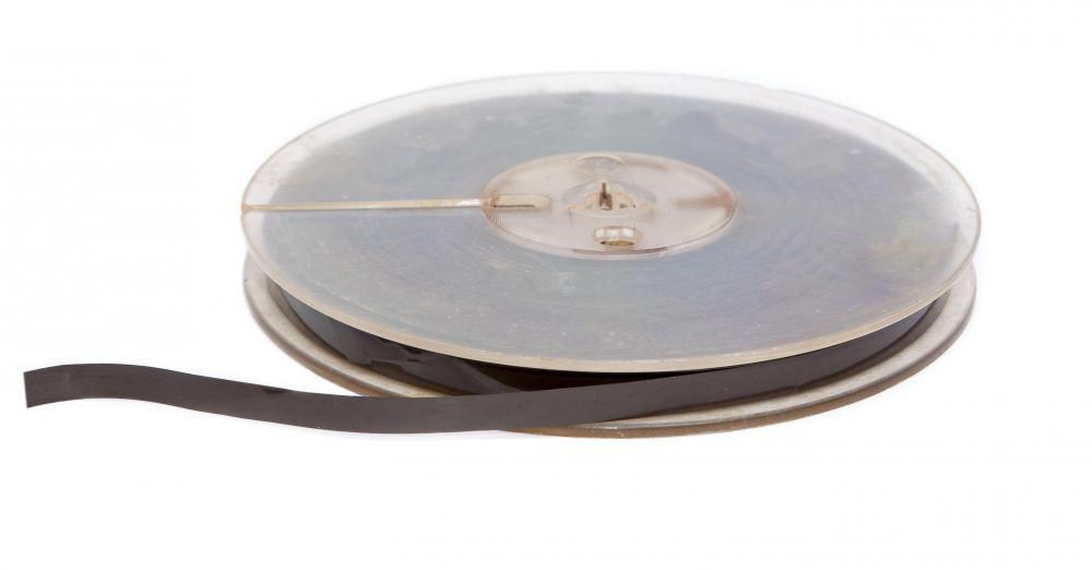 A tape recorder works by running a tape coated with a type of iron oxide over the electromagnetic head of the machine.