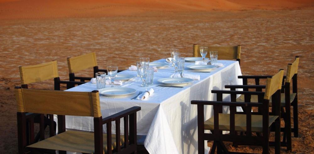 Outdoor eating with full table settings and chairs is essential to glamping.