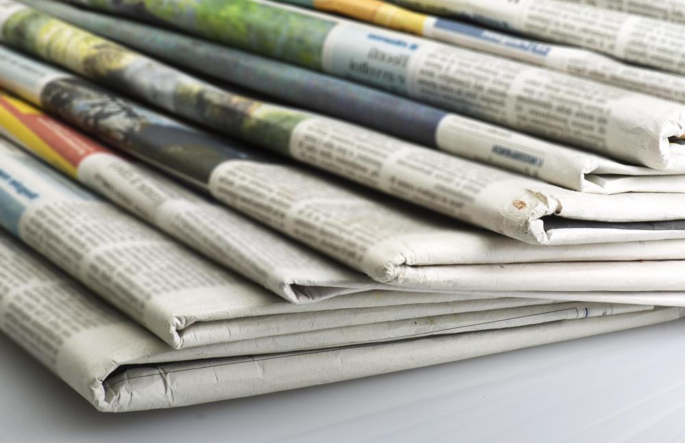 Newsprint inclusion uses torn pieces of old newspaper.