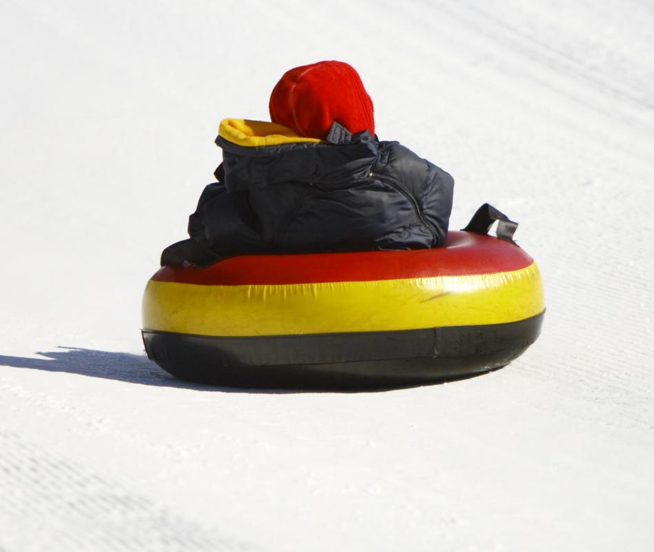 Snow tubing uses an inner tube to go down a snow covered hill.