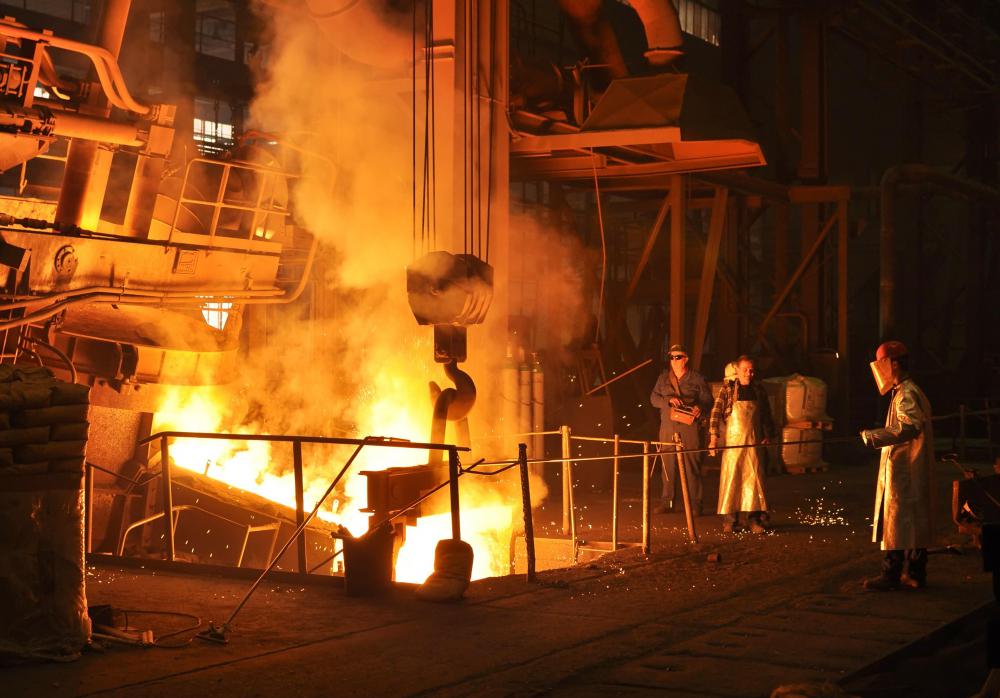 Raw iron ore and other materials are heated in a mill to make steel and iron.