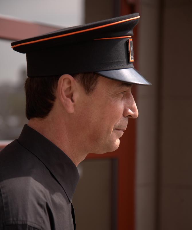 Hotel bellhops help guests with their luggage.