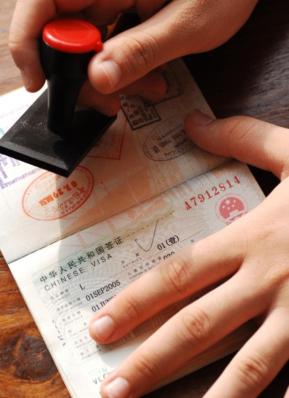 It's not illegal to have your passport stamped from a country where there is a travel warning.