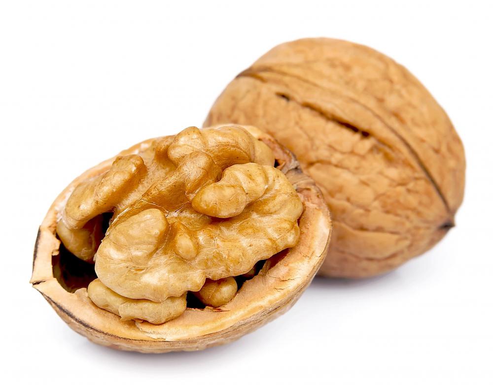 A child can use walnuts to make a three dimensional illustration as part of a Thanksgiving craft project.