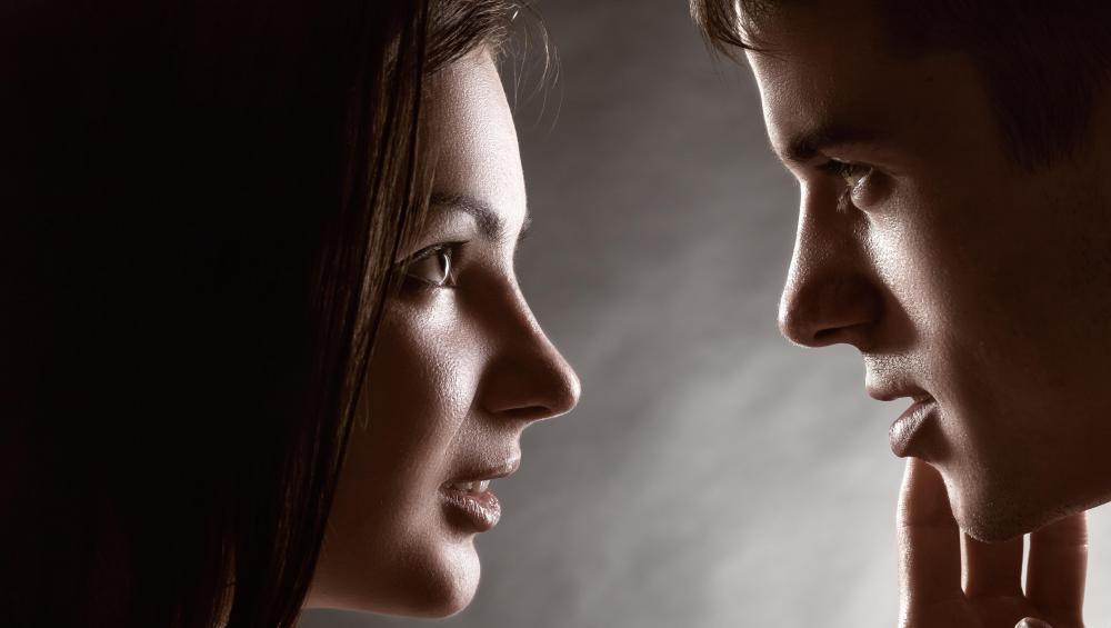 Leaning in closely to have a personal conversation can be a sign of flirtation.