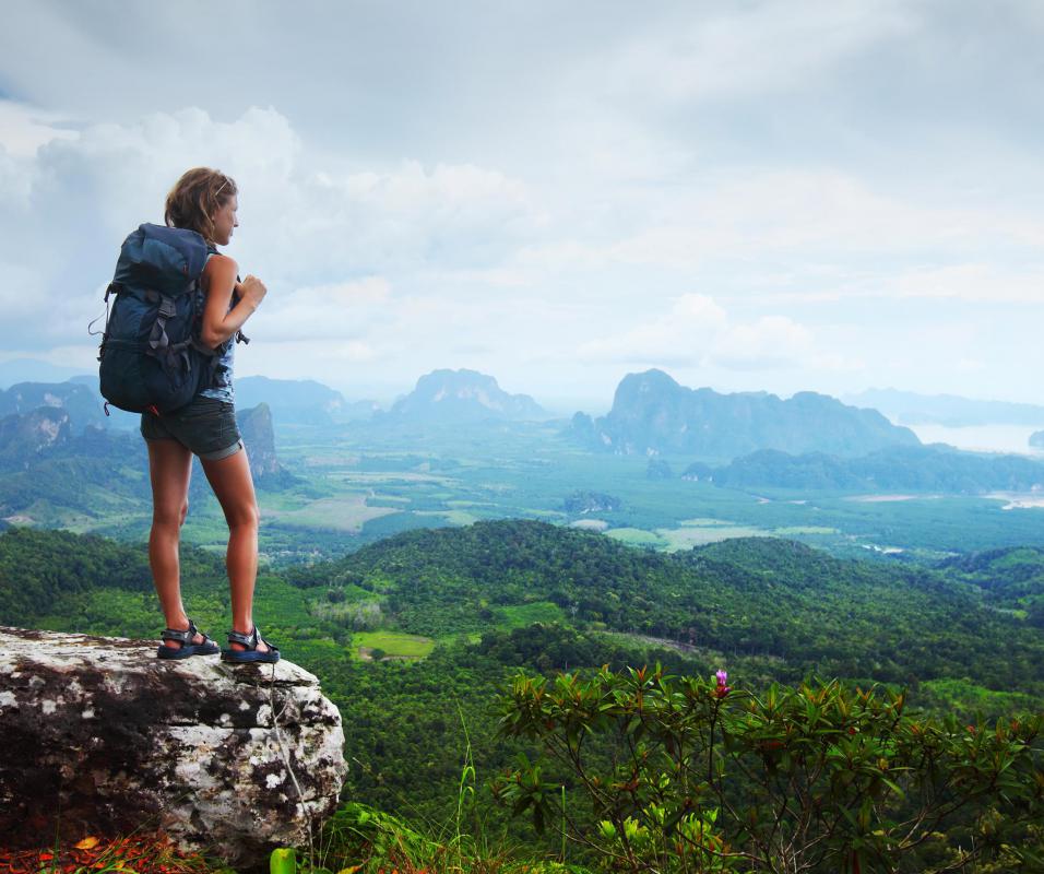 An adventure tour guide directs trekkers to scenic areas.