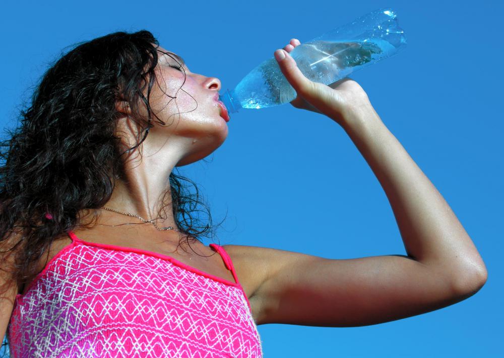 Bringing bottled water can help a person stay hydrated at the beach.