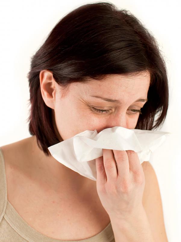 Woman sneezing due to allergic reaction.